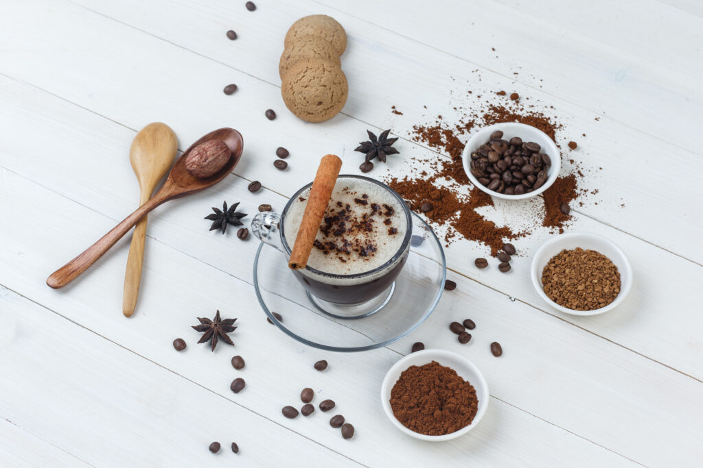 coffee beans, grinded coffee, spices, cookies, wooden spoons 
